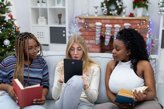 Amazing information read by a student in a tablet on the website. Fellow students from Africa and Europe. Female students with glasses.