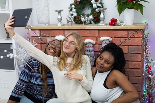 A shared selfie of college friends by a decorated fireplace. Christmas spent among friends from Africa and Europe.