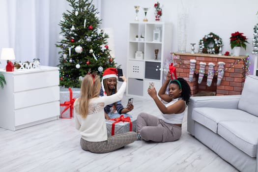 Three virgins celebrate Christmas together. Joyful photos taken with a smartphone. Selfie is a keepsake for selfies and on social media.