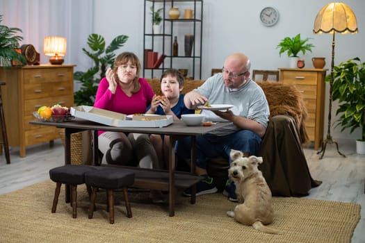 The dog didn't get any slice of pizza and is looking around for the next delivery. The family of her tasty pizza.
