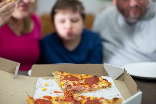 The bellies of the whole family were filled with wonderful pizza. There were still a few pieces of tasty pizza left.