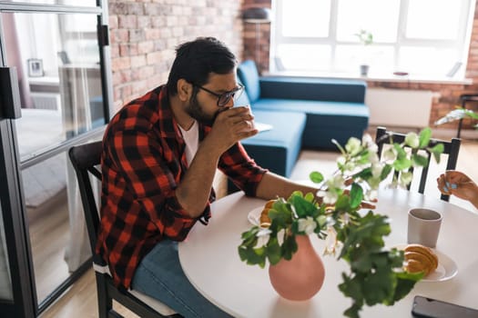 Couple drinking a morning coffee together. Man talks with her wife - lifestyle and communication family