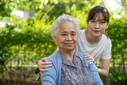 caregiver help and care Asian senior woman patient sitting on wheelchair at nursing hospital ward, healthy strong medical concept.