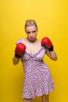 Boxer, seductive confident female boxer with gloves studio, sporty woman posing looking to camera.