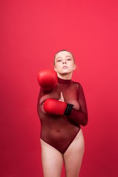 Boxer, seductive confident female boxer with gloves studio, sporty woman posing looking to camera.