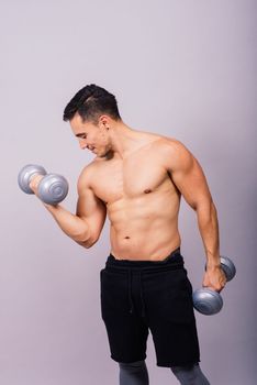 Portrait young fitness sporty strong man barechested muscular sportsman isolated on grey dark.