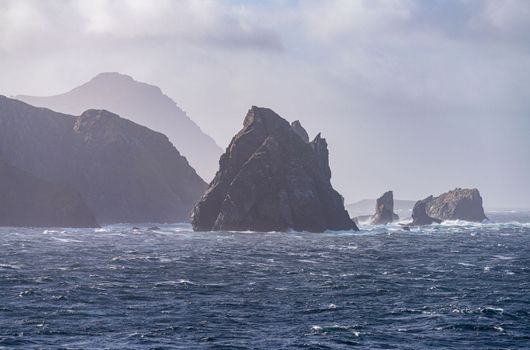 Jagged rocky outcroppings off Hornos Island near Cape Horn in Chile