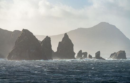 Jagged rocky outcroppings off Hornos Island near Cape Horn in Chile