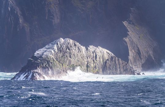 Rocky cliffs give place for flocks of seabirds at Cape Horn on Hornos Island in Chile