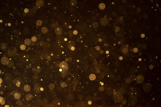 Organic bokeh dust particles floating on light beam on black background. Glittering sparkling flickering overlay. High quality photo