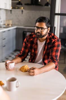 Couple drinking a morning coffee together. Man talks with her wife - lifestyle and communication family