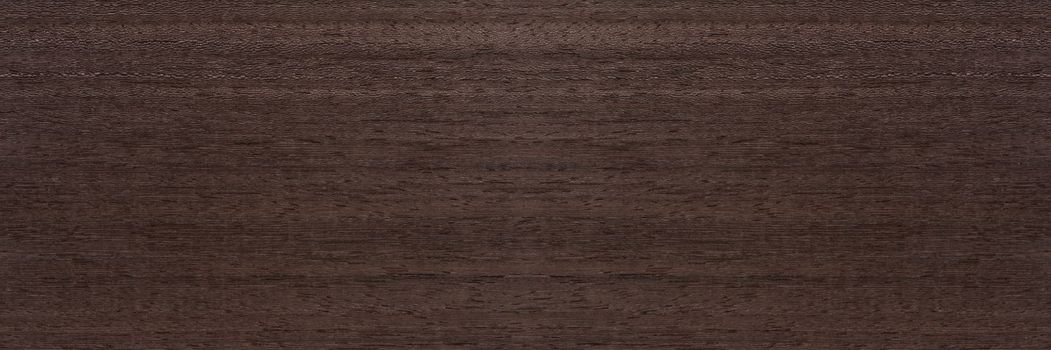 Texture of mahogany. Texture of koto wood with a reddish brown tint. Exotic rare wood from Africa for the production of expensive furniture or interior elements.