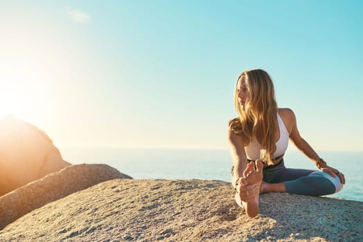 Yoga make me a better me. an athletic young woman practicing yoga on the beach