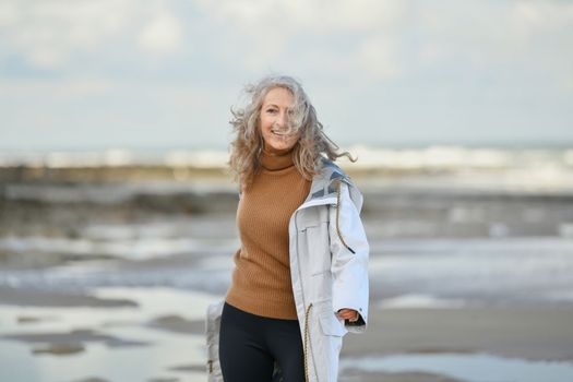 Portrait of a fifty-year-old woman with a white smile