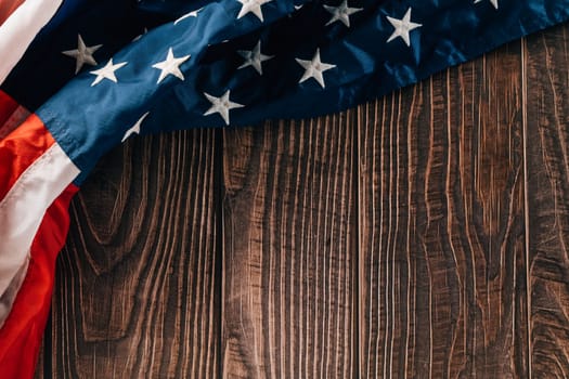 Top view USA flag on brown old wooden background board, flag of United States America with copy space, banner design, Patriot Day, Independence Day, Happy presidents day
