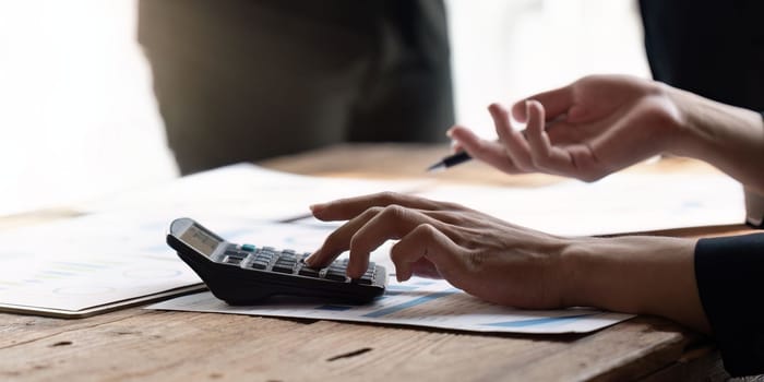 female employee working on a laptop computer in a modern office. Make an account analysis report. real estate investment information financial and tax system concepts.