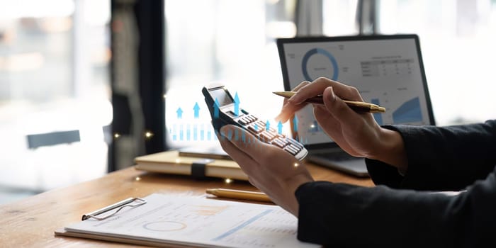 female employee working on a laptop computer in a modern office. Make an account analysis report. real estate investment information financial and tax system concepts.