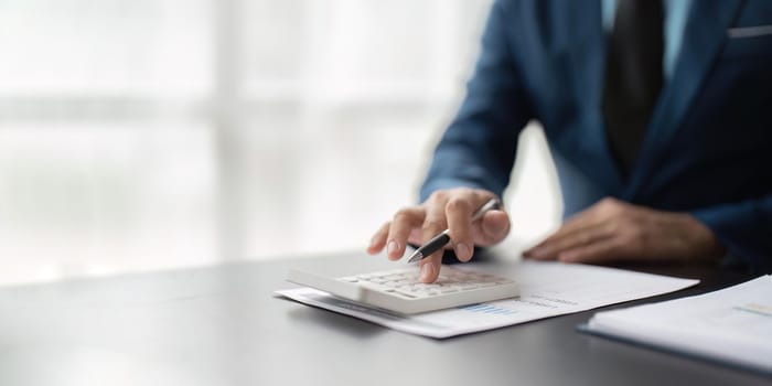 Businessman calculating the financial statement of his business. Accounting and Tax.