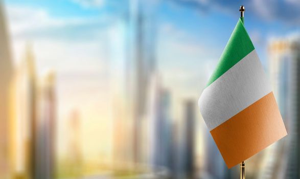 Small flags of the Ireland on an abstract blurry background.