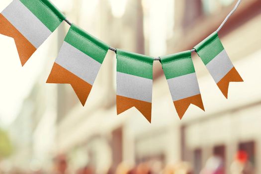 A garland of Ireland national flags on an abstract blurred background.