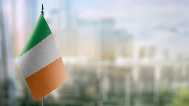 Small flags of the Ireland on an abstract blurry background.