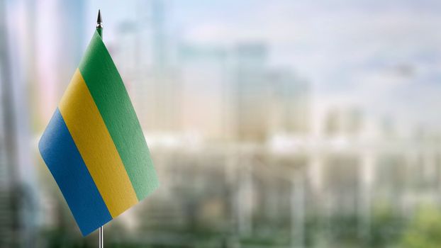 Small flags of the Gabon on an abstract blurry background.