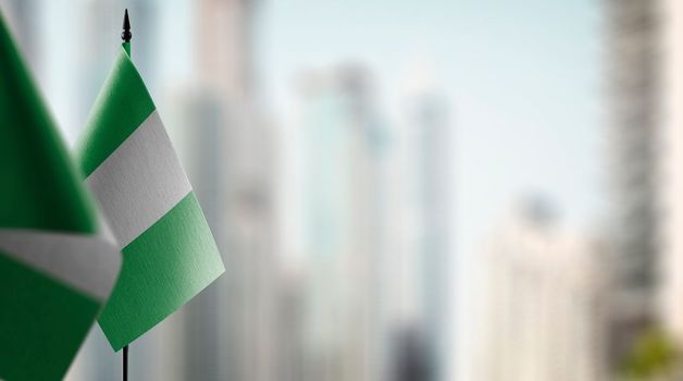 Small flags of the Nigeria on an abstract blurry background.
