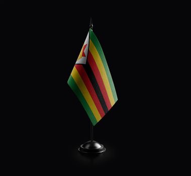 Small national flag of the Zimbabwe on a black background.
