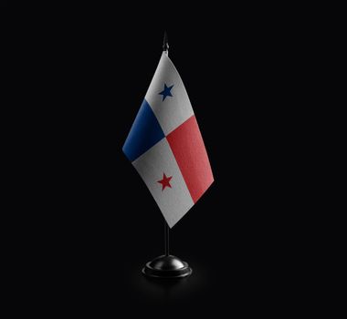Small national flag of the Panama on a black background.
