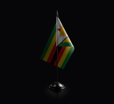 Small national flag of the Zimbabwe on a black background.