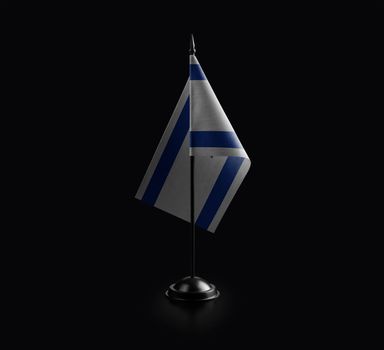 Small national flag of the Israel on a black background.