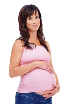 Considering her childs future. A young pregnant woman standing against a white background