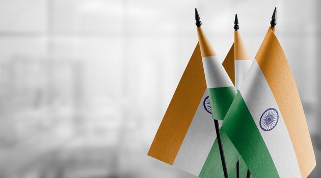 A small India flag on an abstract blurry background.