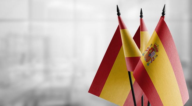 A small Spain flag on an abstract blurry background.