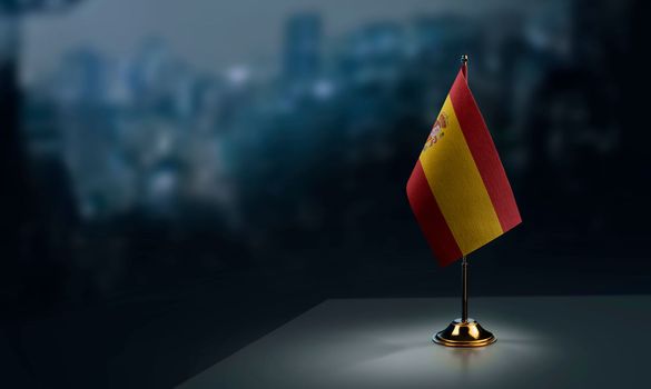 A small Spain flag on an abstract blurry background.