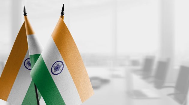 A small India flag on an abstract blurry background.