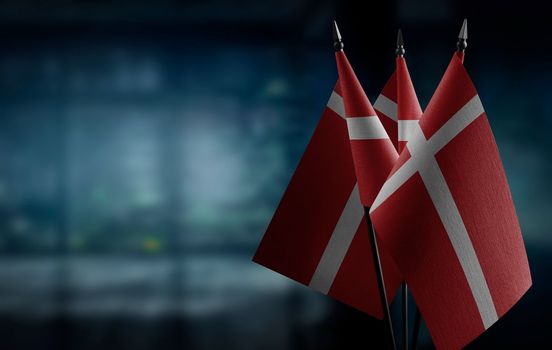 A small Denmark flag on an abstract blurry background.