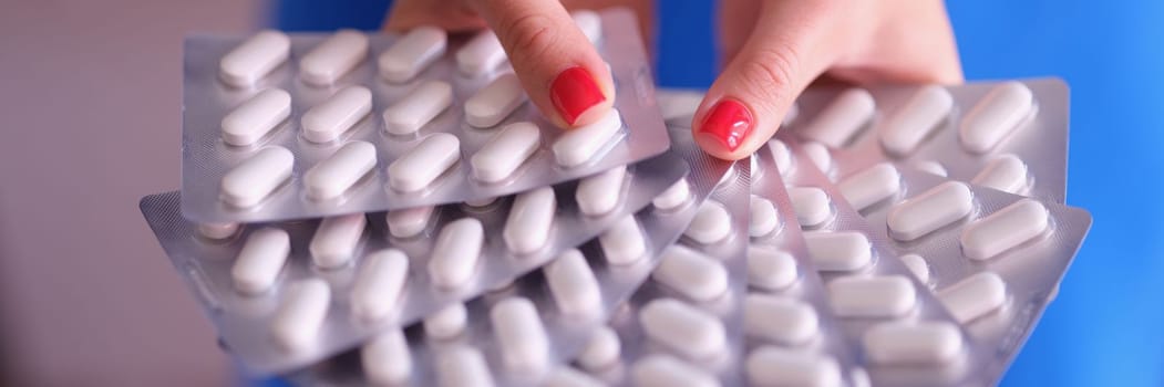 Person holds lot of pills in blister. Health treatment and medical pills