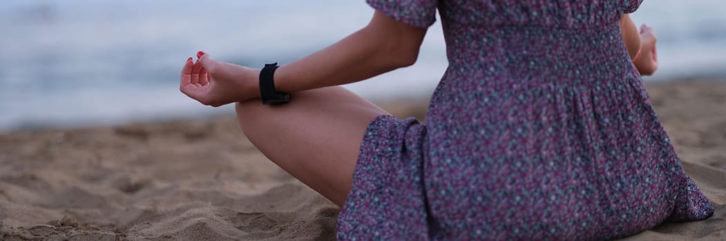 Cropped shot of unrecognizable young woman meditating on beach.Time to meditate