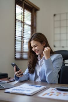 Young happy lucky woman feeling excited winner looking at cellphone using mobile phone winning online, receiving great news or sms offer, getting new job celebrating achievement.