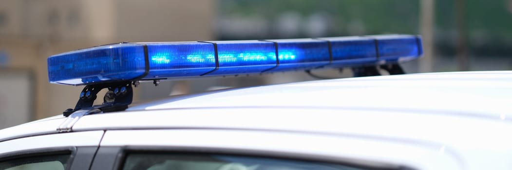 Closeup of blue lights on roof of police car. Police car flashing lights and police car siren