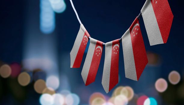 A garland of Singapore national flags on an abstract blurred background.