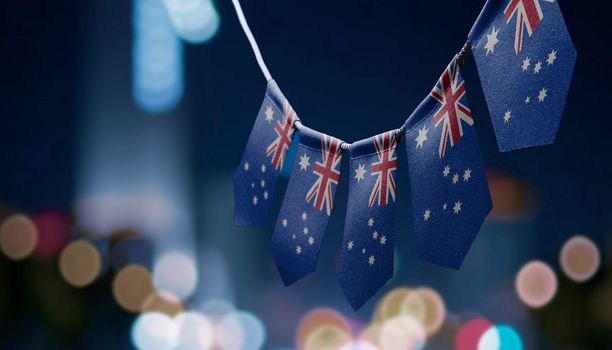 A garland of Australia national flags on an abstract blurred background.