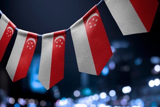A garland of Singapore national flags on an abstract blurred background.