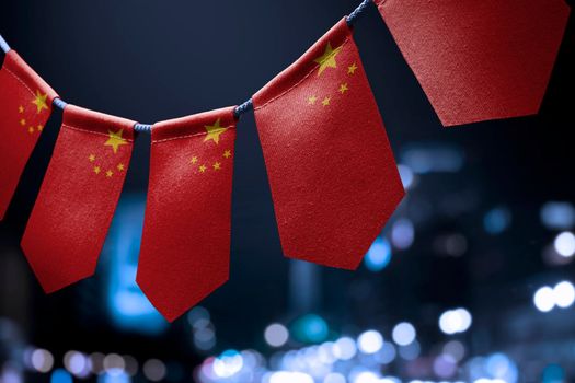 A garland of China national flags on an abstract blurred background.