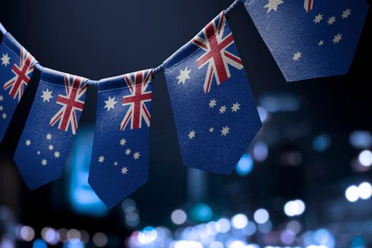 A garland of Australia national flags on an abstract blurred background.