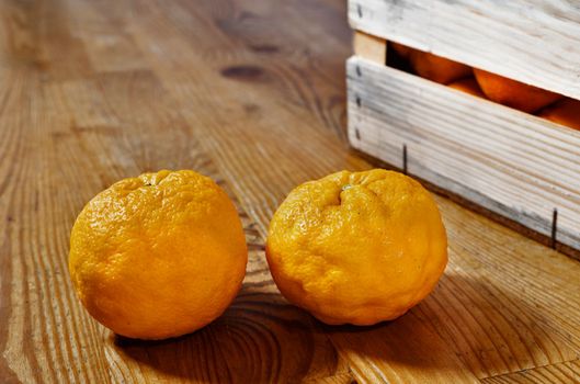 Oranges on wooden table , fruit in crate , healthy eating