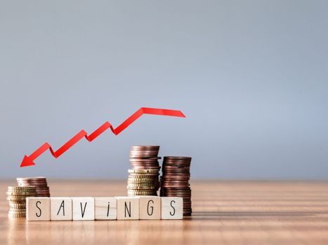 red arrow down graphic. Falling savings or bankruptcy and loss of investment.on gray background. Copy space for text savings in piggy bank and coin stairs poor
