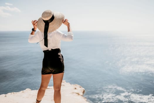 Happy girl doing yoga with laptop working at the beach. beautiful and calm business woman sitting with a laptop in a summer cafe in the lotus position meditating and relaxing. freelance girl remote work beach paradise