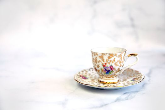 Antique porcelain tea cup on white background copy space. traditional English vintage ceramics crockery